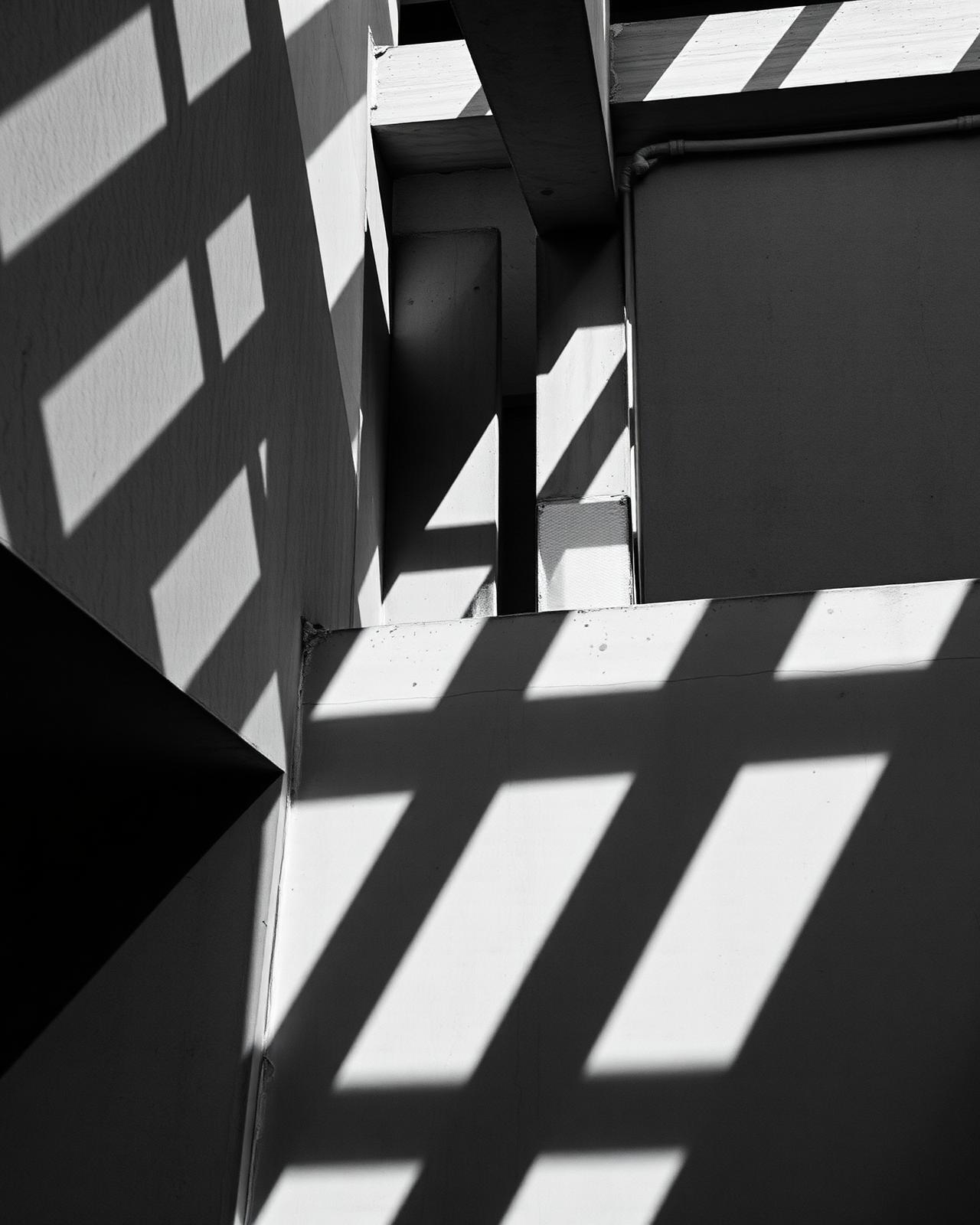 Monochrome architectural shadows on raw concrete